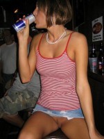 Hottie shows off her slit while drinking a redbull in front of a voyeur