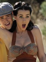 Katy Perry has fun on a bicycle while a voyeur is watching